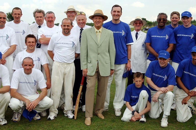 Geoffrey Boycott is pictured with the teams after the charity cricket match for Cancer Research at Rothwell Cricket Club in June 2003.