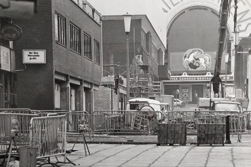 Looking down Victoria Street as work got underway to block pave the pavement
