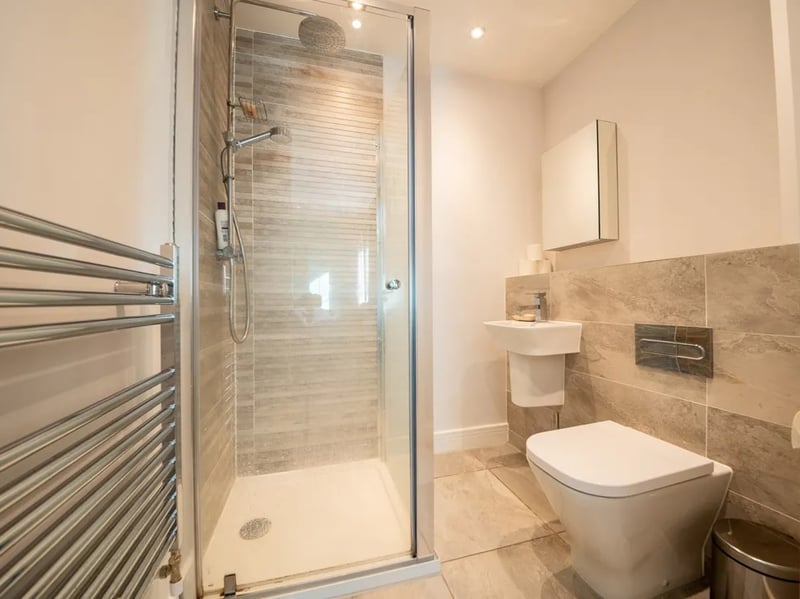 The master en-suite has a modern finish with bright lighting. 