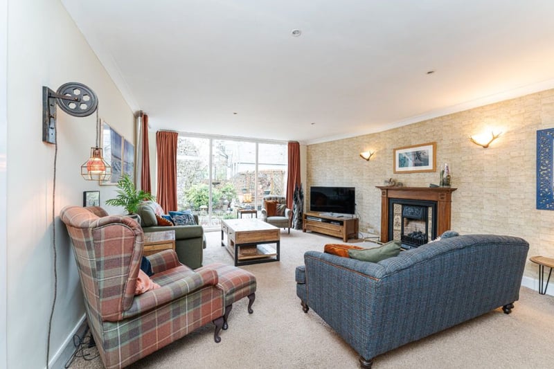 The lovely, well-proportioned south facing living room with patio doors to the rear garden