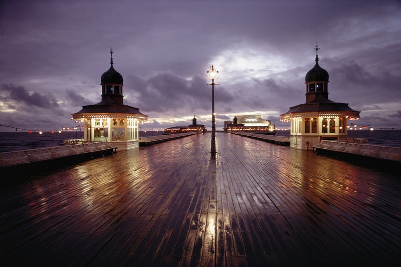 A nightime view of refelctions and illuminations on a rainy Blackpool Pier, November 1970. (Photo By RDImages/Epics/Getty Images)