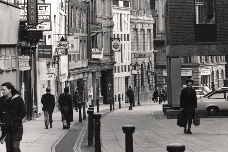 A view of the Cloth Market Newcastle upon Tyne taken in 1977. The photograph is looking down the Cloth Market towards Mosley Street. Buildings on the left-hand side of the street include the 'Wine Cellar' The 'Koh-I-Noor' and 'The Rajah' Indian restaurants 'Balmbra's' and a branch of the Midland Bank. Part of a modern office block can be seen on the right-hand side of the Cloth Market.