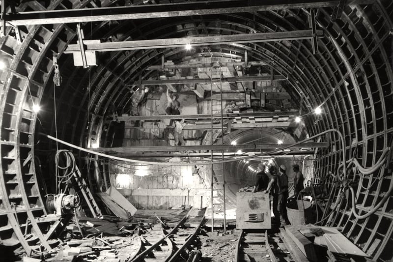 A view of the construction work inside a Metro tunnel Newcastle upon Tyne taken in 1977. The photograph shows men working inside the tunnel.