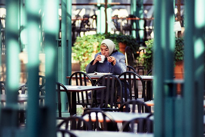 Picture shows a woman alone enjoying her cup of tea in an open air Glasgow cafe in 1990. 