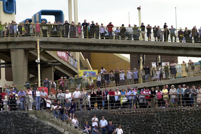 Crowds watching the Red Arrows - part of the Blackpool with Altitude flying displays opposite Blackpool promenade. They are on the old footbridge