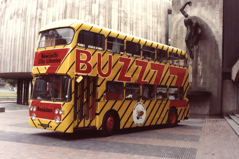A view of the Bookbus Newcastle City Libraries Newcastle upon Tyne taken in 1977. The photograph shows the Bookbus parked in front of the Civic Centre. The statue of the River God can be seen on the wall behind the bus.
