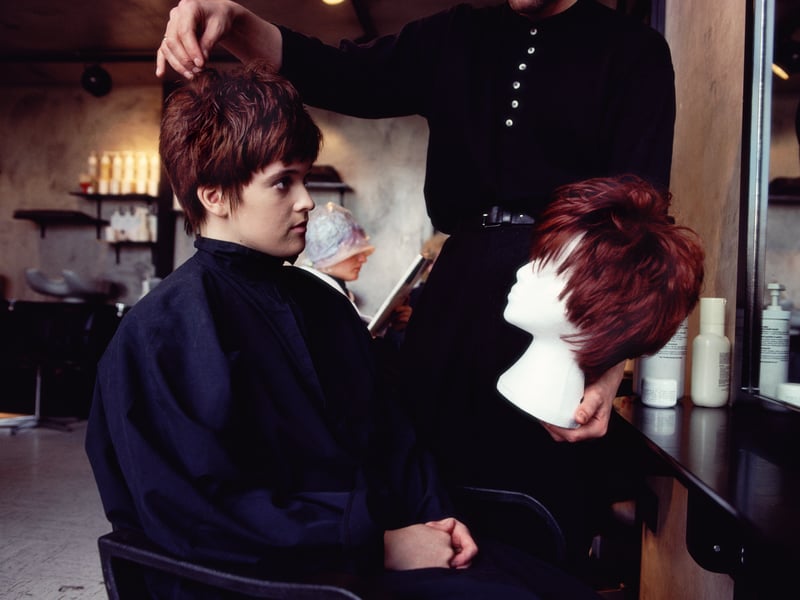 Getting the latest hair style at the salon in March 1990.