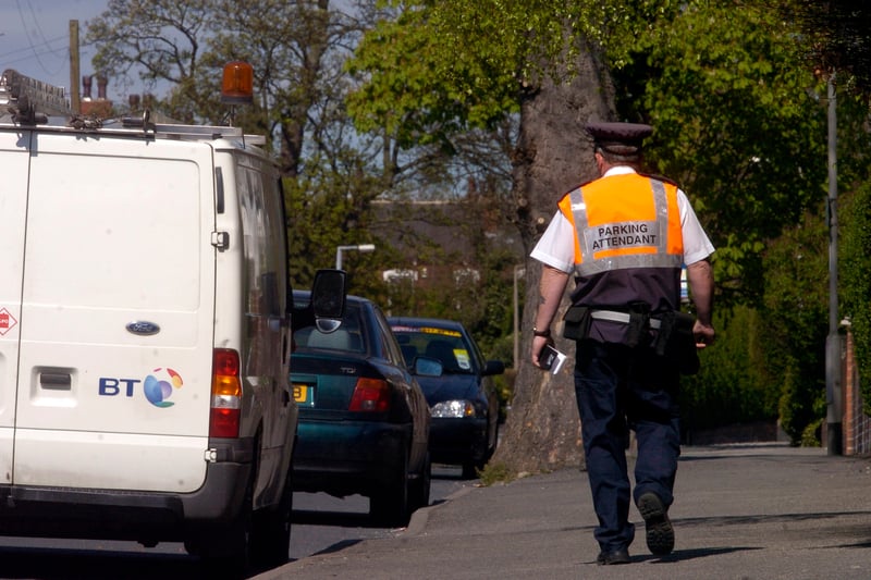 A parking attendant monitors vehicles along Church Lane in April 2007 Residents living the  road complained after many of them had been given parking fines for parking their cars outside their homes.