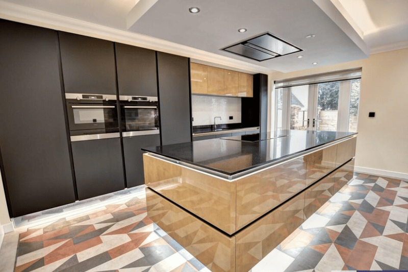 The kitchen area is well presented with a separate island and matte black finishes, as well as built in appliances.