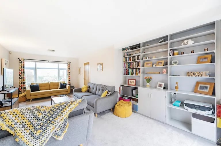 The dual aspect room features a window overlooking the front elevation and bi-folding doors to the rear garden.