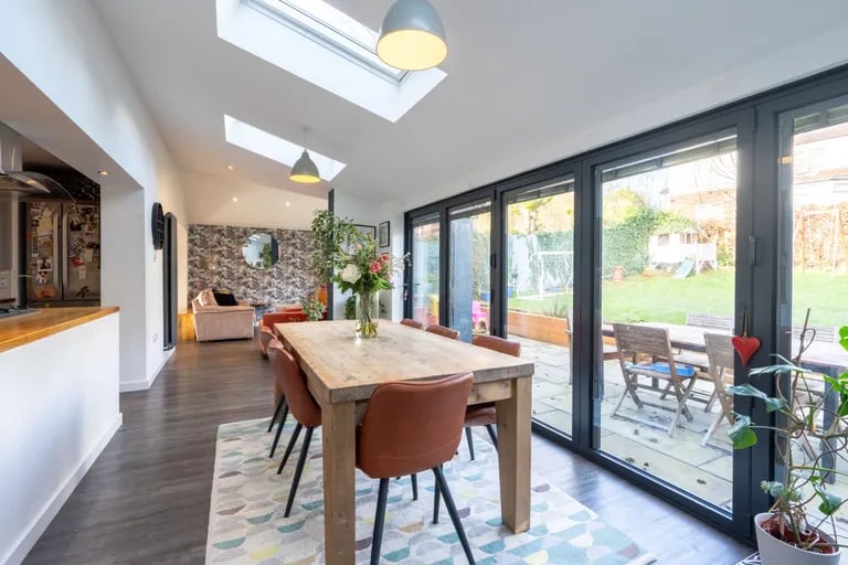 The kitchen opens up to this stunning dining room with skylights and bi-folding glass doors to the rear garden.