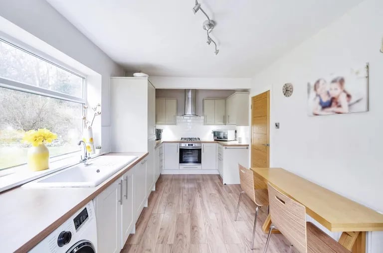 The bright modern style kitchen with a number of appliances and units.