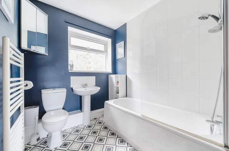 The family bathroom benefits from a bathtub with shower over.