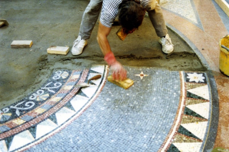 One of the mosaic roundels in the process of being set into the floor of the Victoria Quarter, at the junction of the County and Cross Arcades. They are designed by ceramicist, Joanna Veevers in the tradition of the ancient Romans. Pictured in October 1989.