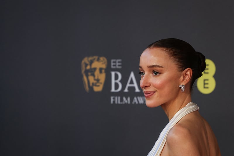 Phoebe Dynevor made an early mark in her career with her role in the crime comedy "Snatch" (2000), where she showcased her talent alongside an ensemble cast. Additionally, her recent portrayal in "The Colour Room" (2021) (Photo by ADRIAN DENNIS/AFP via Getty Images)