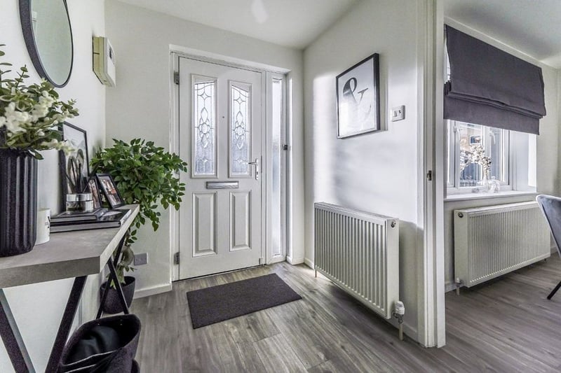 Decorated in modern colour schemes throughout, the property welcomes you with this hallway.