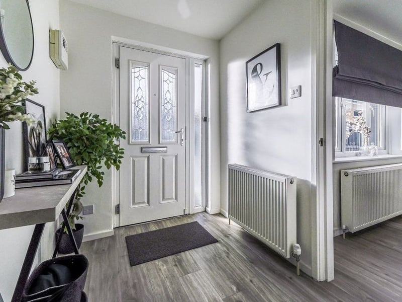 Decorated in modern colour schemes throughout, the property welcomes you with this hallway.