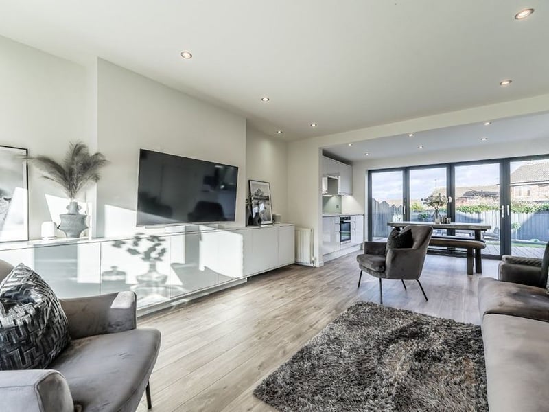 It combines the living room to the front and open dining kitchen to the rear.