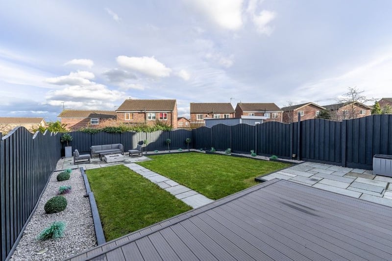 The generous landscaped garden is mainly laid to lawn with composite decking.