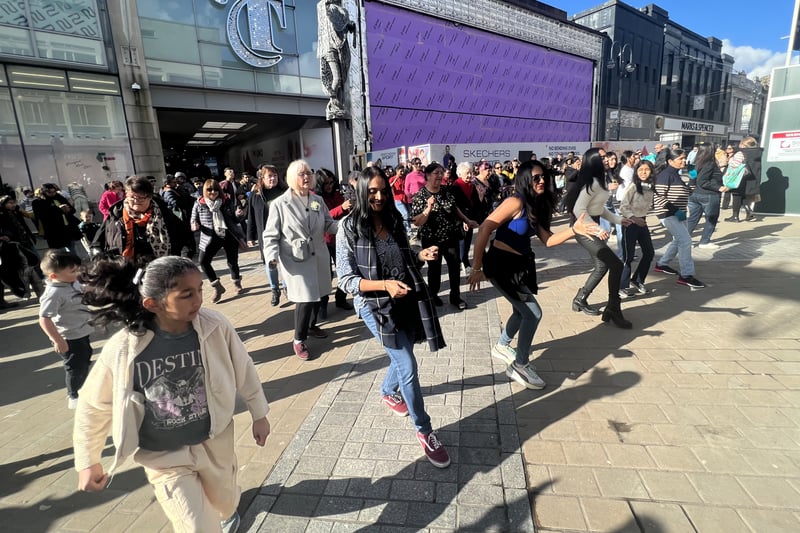 Passers-by joined the fun as the flash mob grew, turning Briggate into a spontaneous dance party.