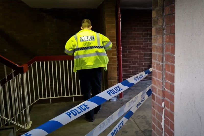 Forensic specialists were  examining a stairwell at ?Cliff Street flats after a masked gang stabbed two men.
