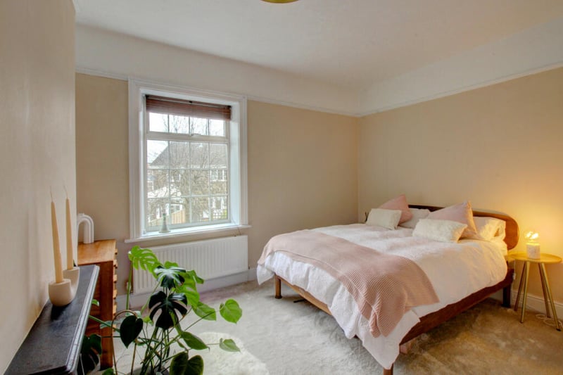 Upstairs is a spacious master bedroom with built-in cupboards.