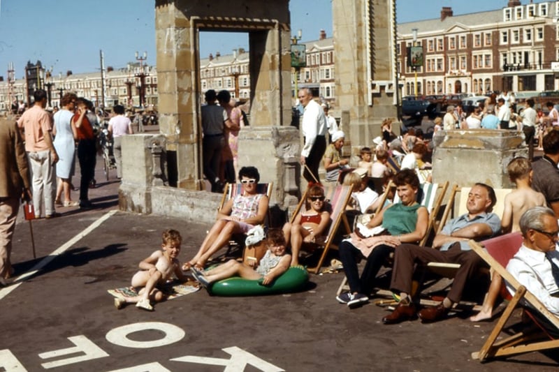 People enjoying a day out in Blackpool, 1966, at the side of the paddling pool on the prom. It's long gone and is now the site of the world's largest mirror ball. Carole Green, who loaned the photo and whose family are pictured, said: "We spent many a happy hour playing in the area"