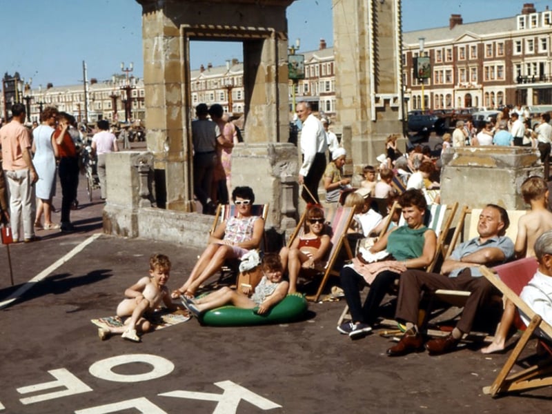 People enjoying a day out in Blackpool, 1966, at the side of the paddling pool on the prom. It's long gone and is now the site of the world's largest mirror ball. Carole Green, who loaned the photo and whose family are pictured, said: "We spent many a happy hour playing in the area"