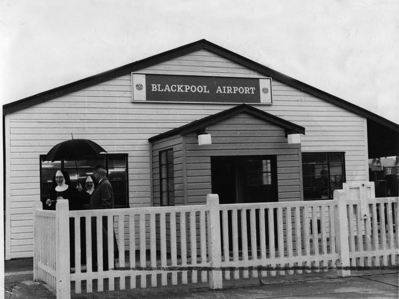 Terminal building 1965, with (left) a gallant chap
shielding two nuns from the rain