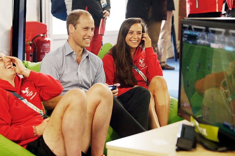 Prince William, Duke of Cambridge plays a game of FIFA during a visit to the Commonwealth Games Village.