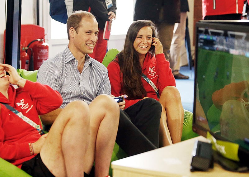 Prince William, Duke of Cambridge plays a game of FIFA during a visit to the Commonwealth Games Village.