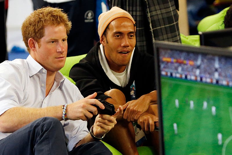 Prince Harry plays a computer game during a visit to the Commonwealth Games Village on July 29, 2014 in Glasgow, Scotland. 