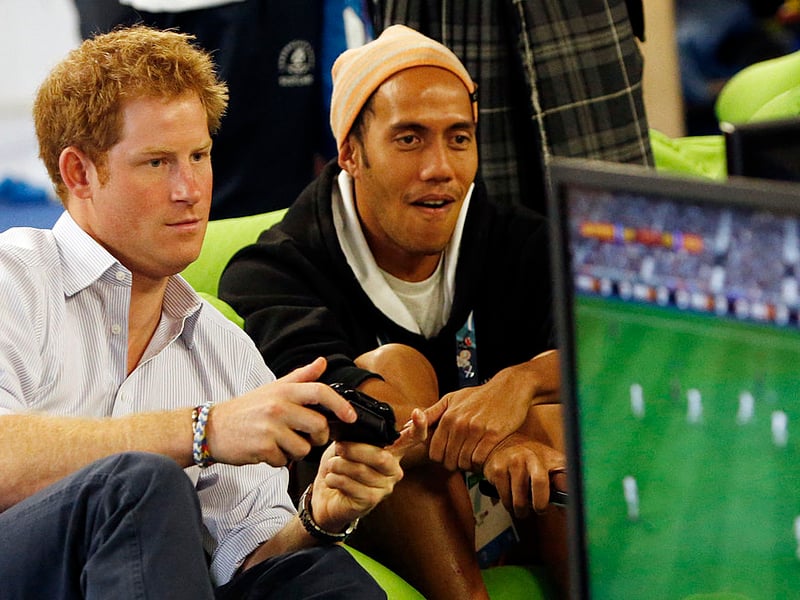 Prince Harry plays a computer game during a visit to the Commonwealth Games Village on July 29, 2014 in Glasgow, Scotland.