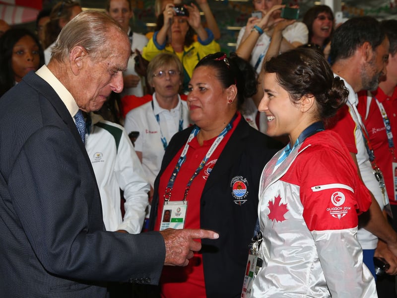 Prince Phillip is greeted by Canadian athlete Isabelle Despras during a visit to the Athletes Village during the Commonwealth games.