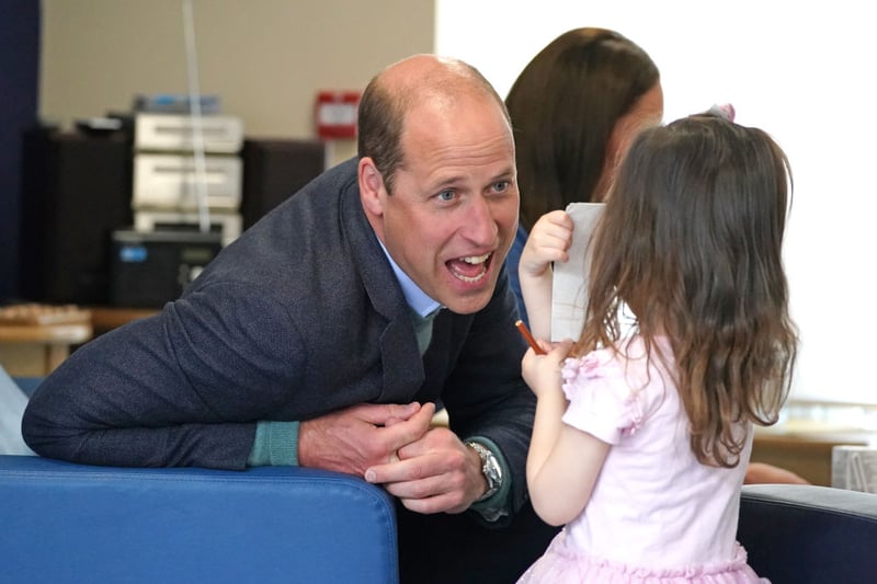 The Duke of Cambridge speaks to Olivia Wilson, two, during a visit to the Wheatley Group in Glasgow, to hear about the challenges of homelessness in Scotland, on May 11, 2022 in Glasgow, Scotland. 