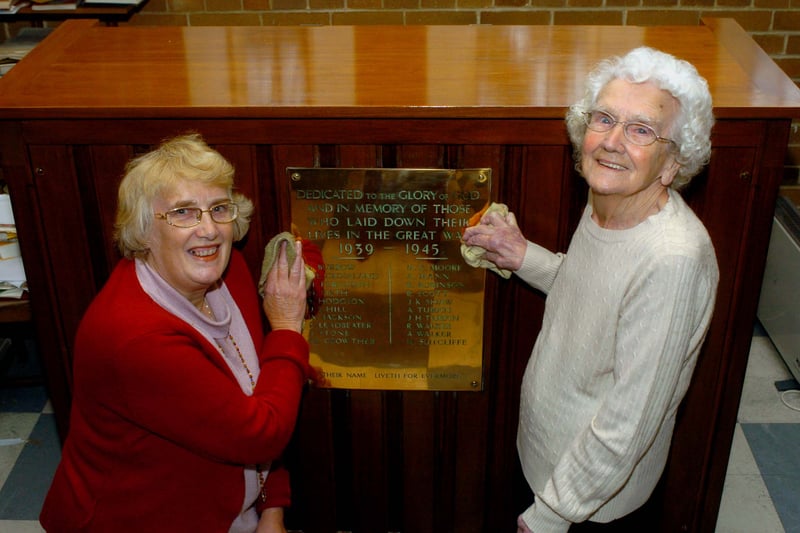 Anne Ward, left,. and Bertha Towers polish the plaque to the district's 20 war dead inside the Church of the Ascension in Seacroft in October 2007.