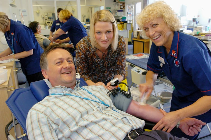 Calendar weather man Jon MItchell was giving his first pint of blood and fellow presenter Kerrie Gosney who is a regular donor help registered nurse Carole Mallinson at the Seacroft Donor Centre. Pictured in July 2007.