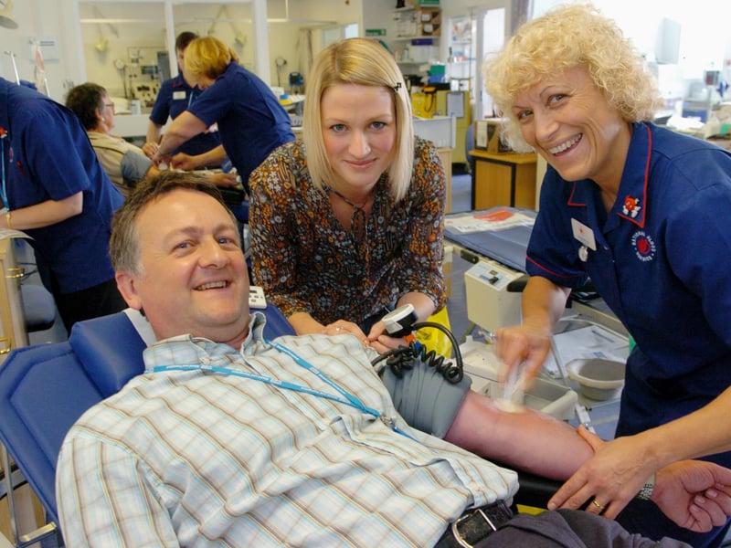 Calendar weather man Jon MItchell was giving his first pint of blood and fellow presenter Kerrie Gosney who is a regular donor help registered nurse Carole Mallinson at the Seacroft Donor Centre. Pictured in July 2007.