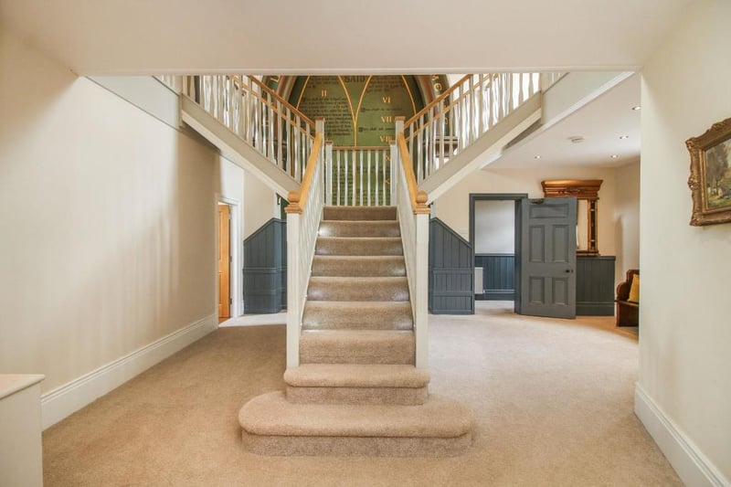 A grand staircase greets those who enter the property.