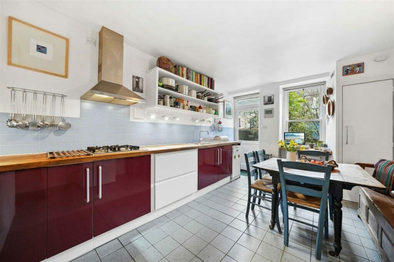 Inside the fitted bright kitchen space with integrated appliances which has a door leading to the back garden. 