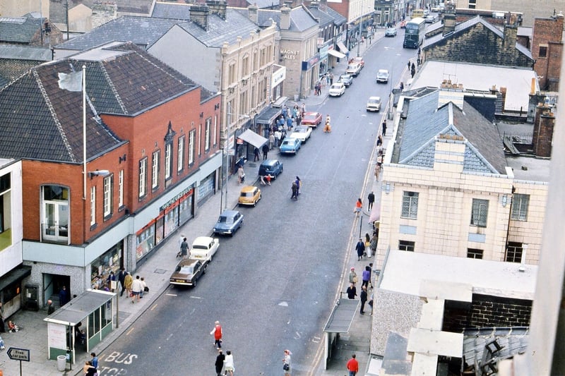 A photo looking straight along Queen Street southwards from the Town Hall tower. The Co-operative Society is still functioning in the Emporium building on the left and quite a lot of the buildings have been recently sandblasted. Bus shelters rather than just bus stops have been introduced though as yet there is no pedestrian crossing. Pictured in June 1973.