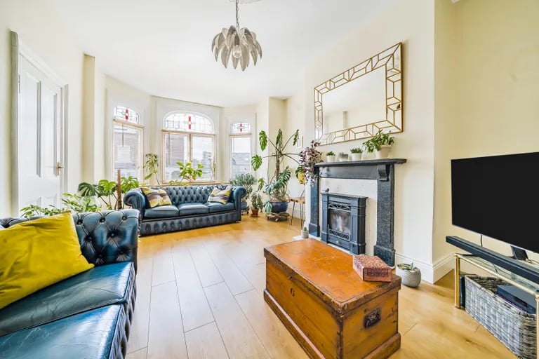The fantastic size living room boasting a large bay window letting in lots of natural light.