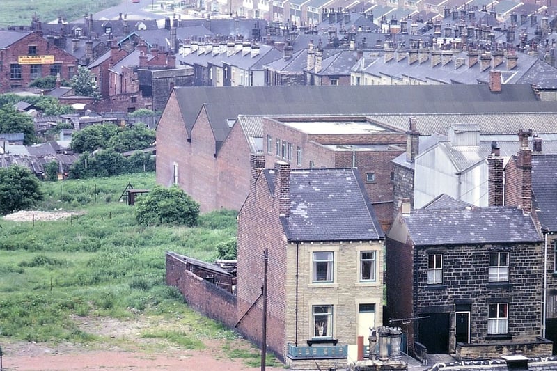A view taken by telephoto lens from the tower of Morley Town Hal.  In the foreground is part of the Mercantile Club, the car park behind it and some houses in Marshall Street. Behind these are the buildings of a small factory on Ackroyd Street. Pic