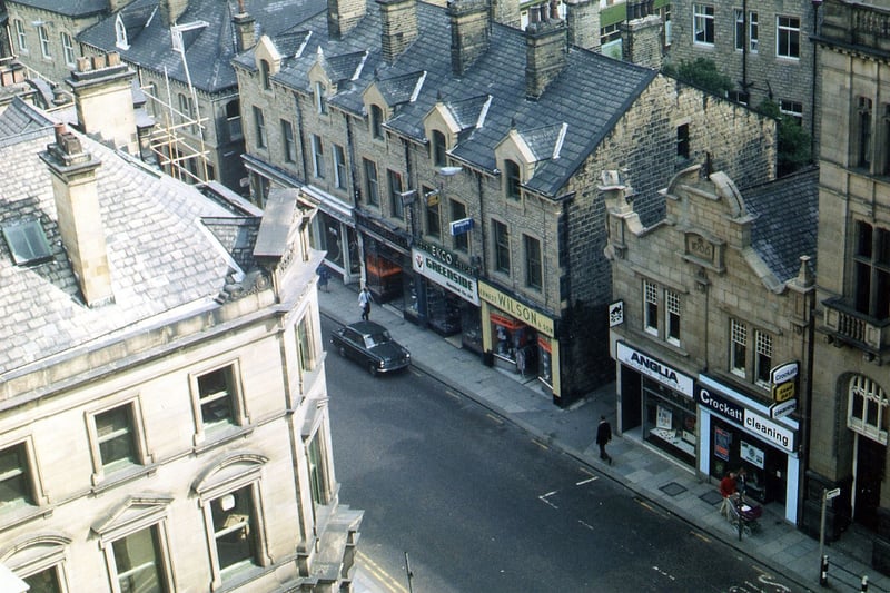 A view from the upper level of the Town Hall showing businesses and shop properties in Queen Street Greenside Electrical co. Ltd. at number 83 Queen Street is in the centre, followed by Ernest Wilson & Son at number 85. Then Anglia Building Society at 87 and on the right, Crockatt Cleaning at number 89. The large building on the left is a bank at number 44 Queen Street at the junction with Wellington Street. Pictured in June 1973.