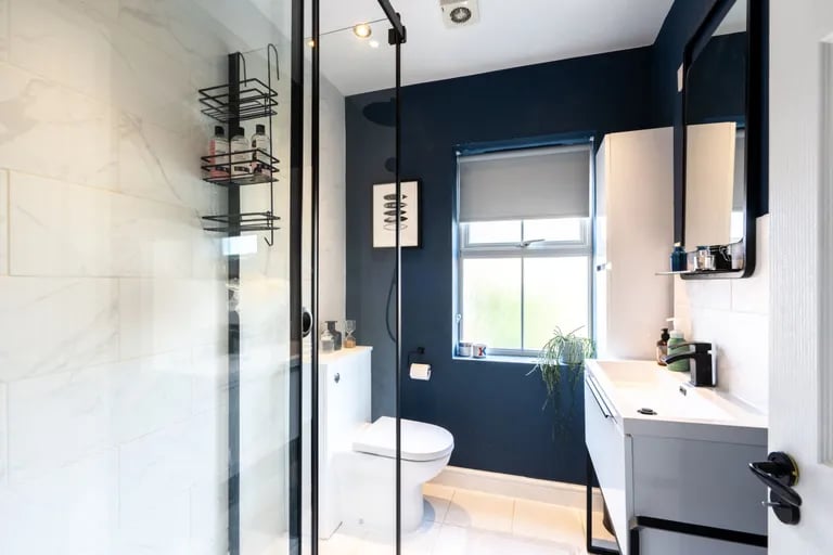 The modern en-suite features  a good-size shower cubicle.