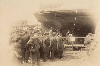 The launch of the ferry steamer Finnieston at William Simons & Co's shipyard, Renfrew in 1890. This was the first elevating deck ferry operating on the River Clyde. The platform was raised and lowered by steam winches depending on the tide level, so that the vehicle deck could reach the landing quays. The ferry could carry up to eight carts and 300 passengers.