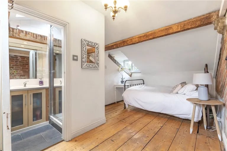 On the top floor is a stunning double bedroom with exposed ceiling beams and en-suite bathroom.