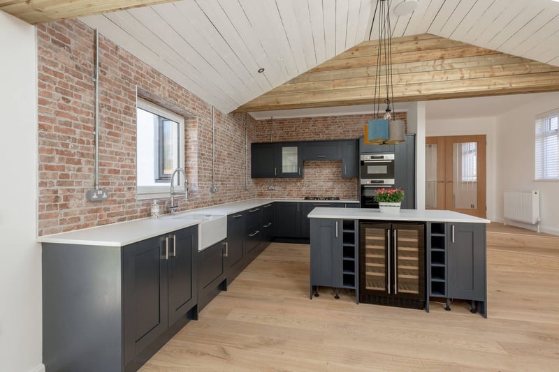 The stylish open plan fully fitted kitchen has feature brick walls and integrated appliances including a wine fridge and double oven, there is also built-in surround sound speaker system that works on the TV and on bluetooth.
