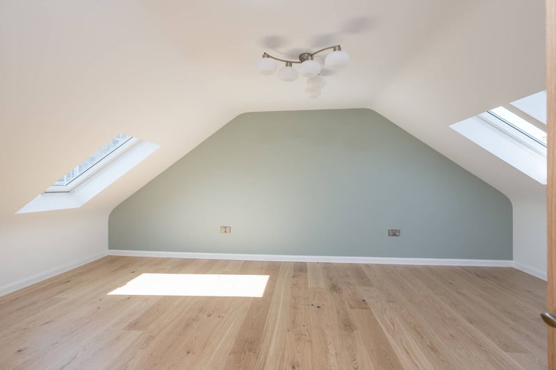 On the upper level is an open hallway with space for a seating area, two further double bedrooms.