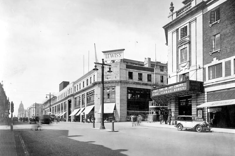 Looking across junction with New Briggate, Odeon Cinema on right in July 1934. Lewis's store, then one of the largest to be built in the North of England. Work began in 1930, it was opened in September 1932 but was not completed until 1939, when three more floors had been added. On front of store is an appeal for funds for Leeds General Infirmary. Leeds Town Hall can be seen on the left.